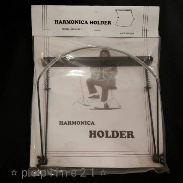 Elton deals harmonica holder