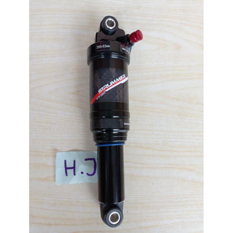 Rear store shock strummer